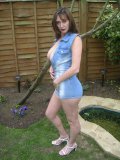 Exhibitionist MILF showing off her classy rack among the trees in her garden