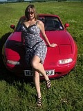 Wild brunette housewife posing in the car and showing her massive bare boobs outdoors