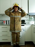 Naughty mature blonde posing as a sexy firefighter and smearing whipped cream all over her boobs