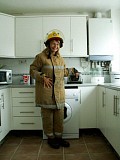 Naughty mature blonde posing as a sexy firefighter and smearing whipped cream all over her boobs