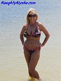Wild blonde hoe doesn't fear getting caught while she shoves a huge dildo in her on a public beach