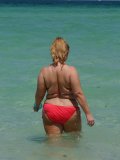 Its summer! Hot chick strips in the sea and enjoys her nude swimming with total joy!
