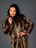 Sexy brunette milf posing in a fur coat and revealing her furry pussy