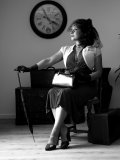 Busty MILF gets rid of her vintage outfit nice and slow on black-and-white pics