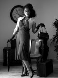 Busty MILF gets rid of her vintage outfit nice and slow on black-and-white pics