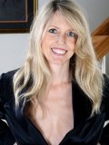 This blond mommy wearing nothing under her black coat is a real exhibitionist