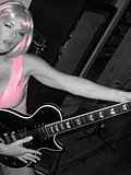 Wild slut with sexy pink hair flashes her juicy breasts and strums a guitar