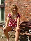 Hot pictures of a gorgeous blonde milf teasing by lifting her dress up to flash her white panties