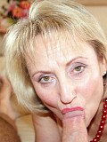 Horny blonde mature wife Michelle wraps her plump red lips around her hubby's thick cock