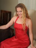 Horny chick strips off her red gown and exposes her tantalizing body figure on the couch!