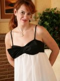 Red-haired housewife tugs on her panties making the thong disappear in her pussy