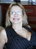Naughty mature housewife lying in bed and flaunting her incredible big melons