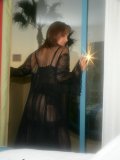 Hot pictures of a wild mature babe posing in a sexy see through black outfit