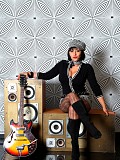 Horny milf Danica posing as a rock star and shoving a guitar in between her massive tits