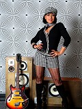 Horny milf Danica posing as a rock star and shoving a guitar in between her massive tits