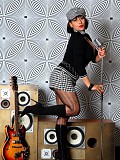Horny milf Danica posing as a rock star and shoving a guitar in between her massive tits