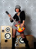 Horny milf Danica posing as a rock star and shoving a guitar in between her massive tits
