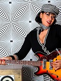 Horny milf Danica posing as a rock star and shoving a guitar in between her massive tits