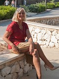 Hot pictures of a gorgeous blonde milf revealing her massive tits outdoors
