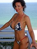 Dirty mature brunette hottie spreads her tight ass and pussy on a balcony