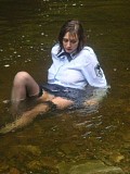 Insanely hot pictures of a horny brunette milf getting wet in the river with her stockings on