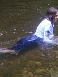 Insanely hot pictures of a horny brunette milf getting wet in the river with her stockings on