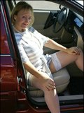 Sassy blonde mature babe exposing her huge melons in the side of the road