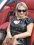 Blonde hottie Michelle exposes her juicy ass in sexy black stockings posing in a car
