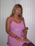 Seductive mature blonde takes her bra off to squeeze and tease her gigantic boobs