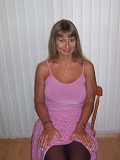 Seductive mature blonde takes her bra off to squeeze and tease her gigantic boobs
