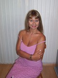 Seductive mature blonde takes her bra off to squeeze and tease her gigantic boobs