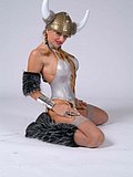 Busty blonde babe poses in her sexy Viking lingerie and spreads her tight holes